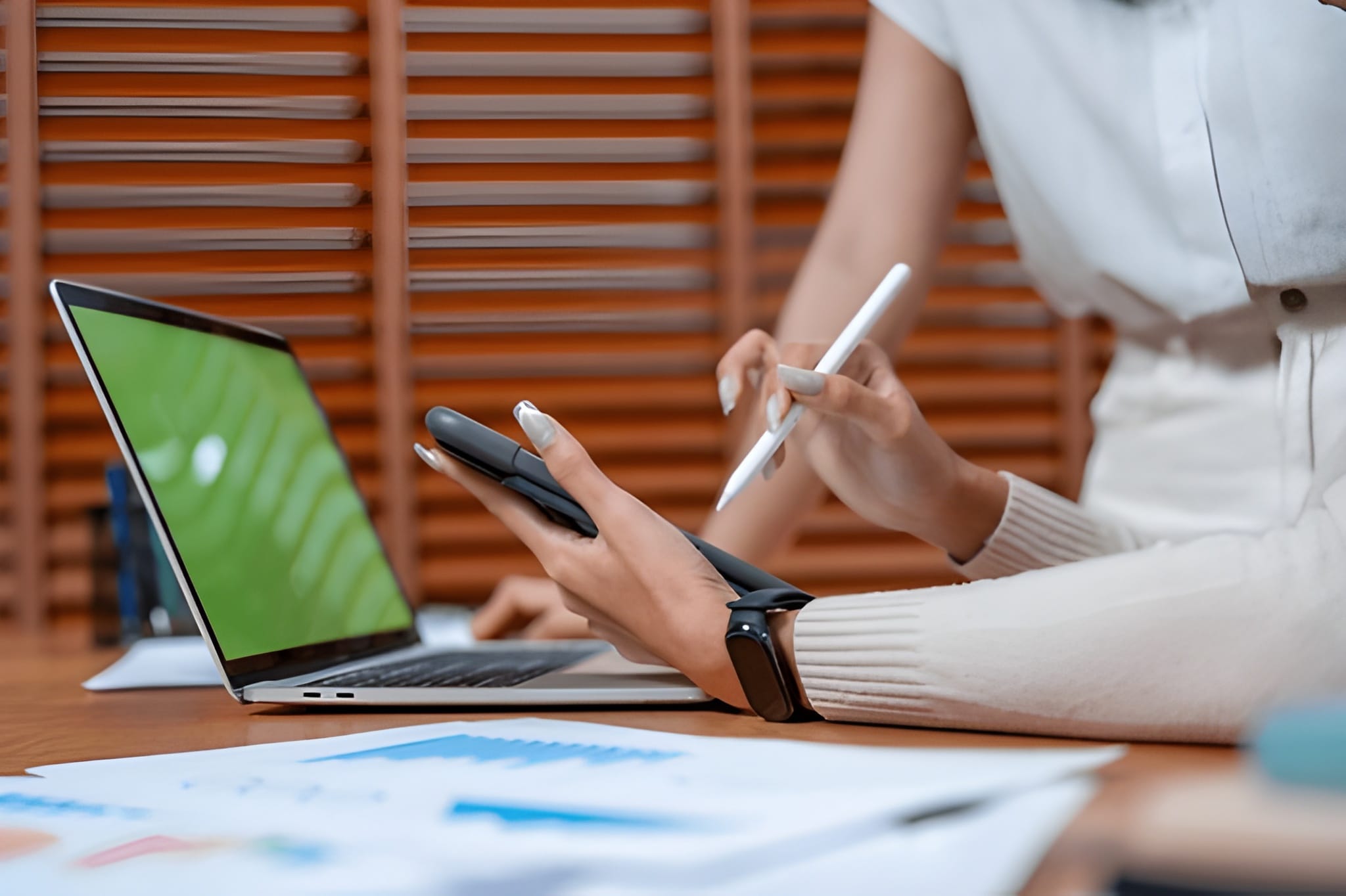 women holding pen and mobile